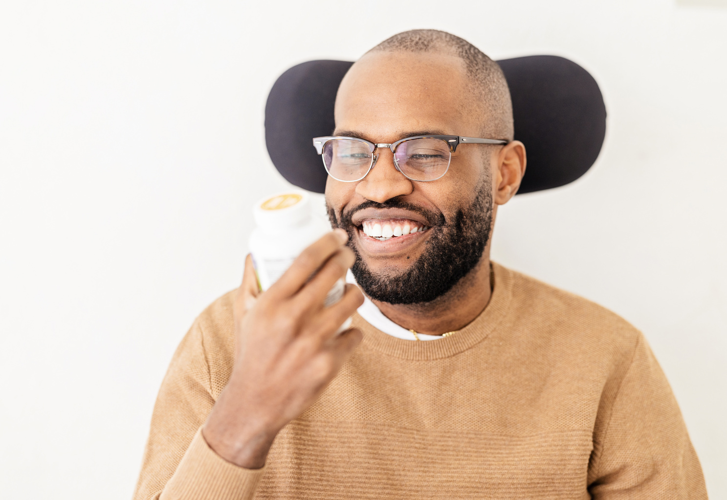 Middle Aged Black Man Holding a Bottle of Pills